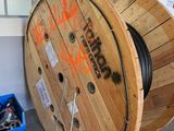 a wooden cable reel with graffiti on the side of it