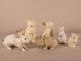a lot of small figurines of animals sitting on a table