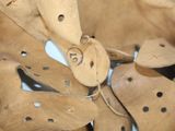 a close up of a wooden object with holes on it