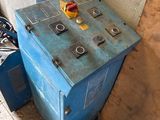 a blue machine that is sitting in the corner of a room