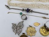 several different types of jewelry are displayed on a white surface