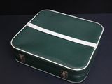 a green suitcase with a white stripe on it