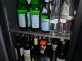 many bottles of water and bottles of wine on the shelves
