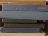 a stack of books sitting on top of a cardboard box