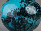 a blue vase with a black and white picture on it