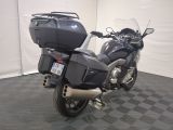 a motorcycle that is parked in a room with a checkered floor