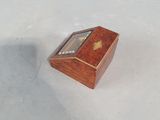 a small wooden box with a clock inside of it