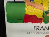 a poster of a soccer player holding a soccer ball