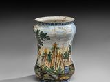 un vase avec un tableau posé sur une table