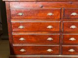 a wooden dresser with many drawers on it in a room
