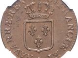 an old coin with a crown on top of it on a white surface