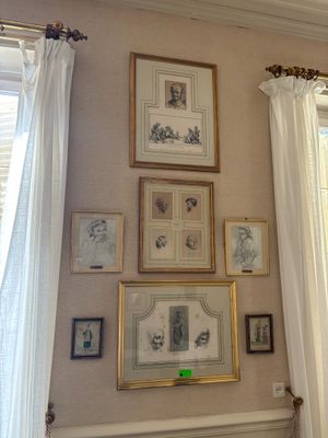 a picture of a living room with a couch and pictures on the wall