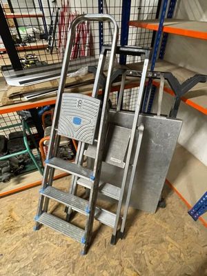 a ladder that is sitting in a room next to some shelves