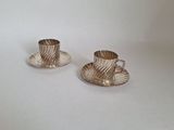 pair of silver plated tea cups and saucers