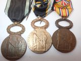 three medals and a ribbon are sitting on a table