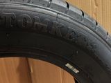 a close up of a tire on a cardboard box with a cardboard box in the background