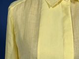 a close up of a yellow shirt on a mannequin