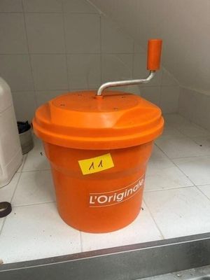 an orange bucket with a handle sitting on a counter