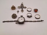 an assortment of jewelry including a watch, bracelet, ring, and other items