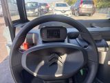 a steering wheel and dashboard of a vehicle with a clock on it
