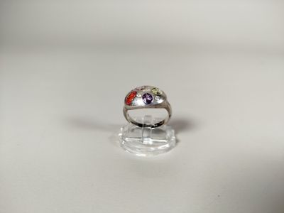 une bague en argent sertie d'une pierre rouge et violette