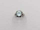 a white gold ring with an aqua blue topaz stone