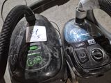 two vacuums that are sitting on the floor next to each other