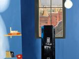 a painting of a suitcase in a room with a window