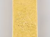 a close up of a gold bar on a white surface
