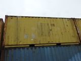 yellow and blue shipping containers stacked on top of each other on a cloudy day