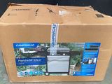 a cardboard box with a picture of a grill inside of it
