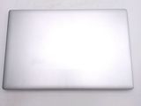 a silver laptop computer sitting on a white surface