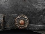 a close up of a helmet with a metal buckle on it