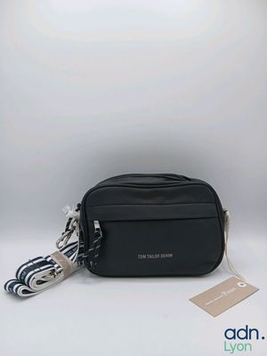 a black cross body bag with a tag on it