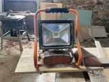 a work light that is sitting on top of a piece of wood