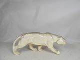 porcelain figurine of a cat walking on a white background