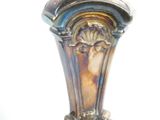 a close up of a vase on a white surface