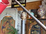 a red umbrella hanging from a metal pole in a room