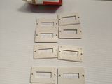 several pieces of white plastic are sitting on a white surface