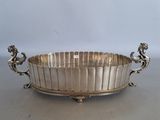 a large silver plate with two lions on the sides of it