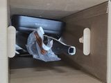a cardboard box with a piece of luggage inside of it