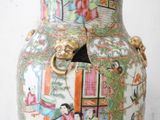 a large vase with a painting on it sitting on a table