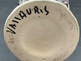 a close up of a small vase with writing on it