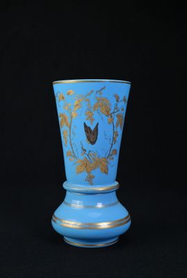 vase bleu avec des motifs dorés sur fond noir