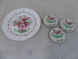 une assiette et quatre petits plats sur la table