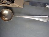 a silver spoon and a silver spoon on a table