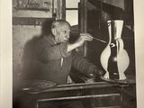 black and white photograph of a man working on a sculpture