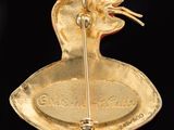 a gold plate with a bird on it on a black background