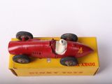 a red toy car sitting on top of a yellow box