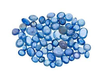 a pile of blue glass pebbles on a white background